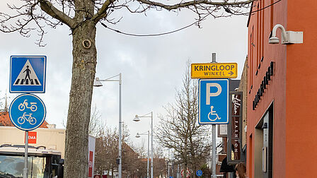 Op de foto is een gehandicaptenparkeerplaats te zien die wordt aangegeven met een bord.